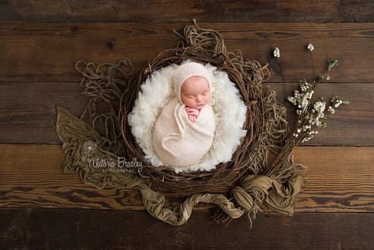 wrapped-newborn-in-rustic-basket.jpg
